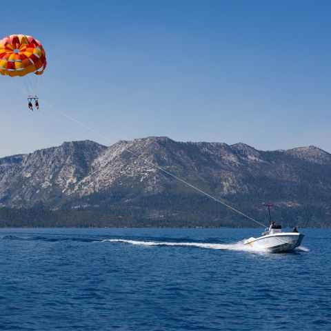 a small boat in a body of water with a mountain in the background