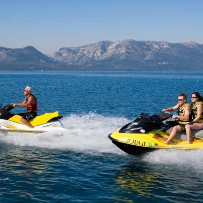 a man riding on the back of a boat in a body of water
