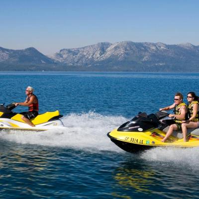 a man riding on the back of a boat in a body of water