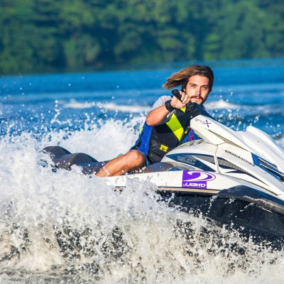 a man riding a wave on a surf board on a body of water