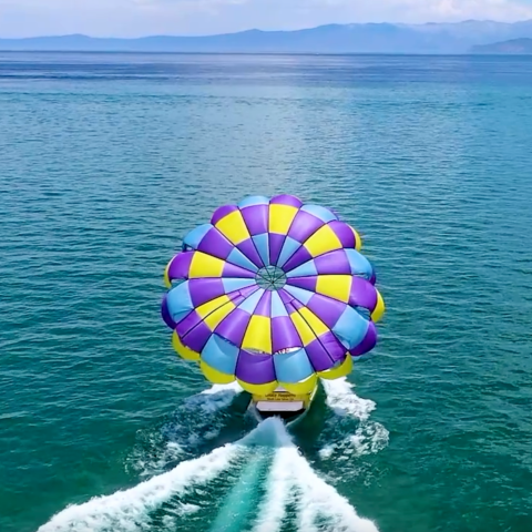 a body of water with a colorful umbrella