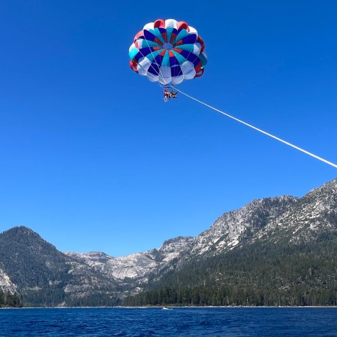 a parachute is flying over a body of water