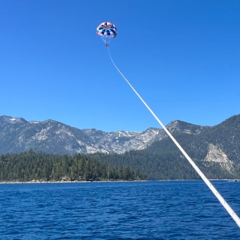 a small boat in a body of water with a mountain in the background
